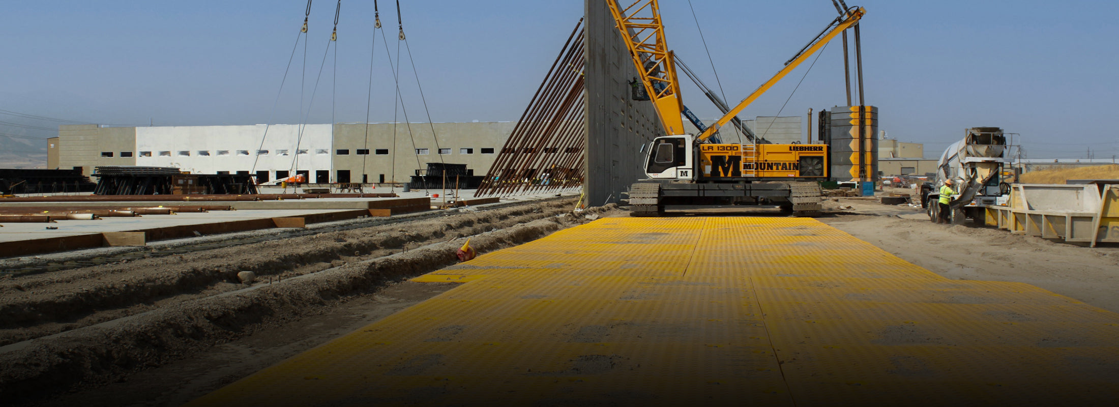 Construction site with a large crane sat on a pad made from XtremeMat ground protection boards